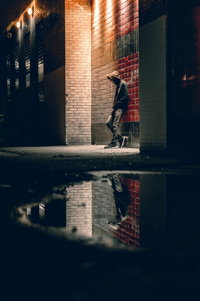 man leaning against a graffitied wall poetry by amy jean