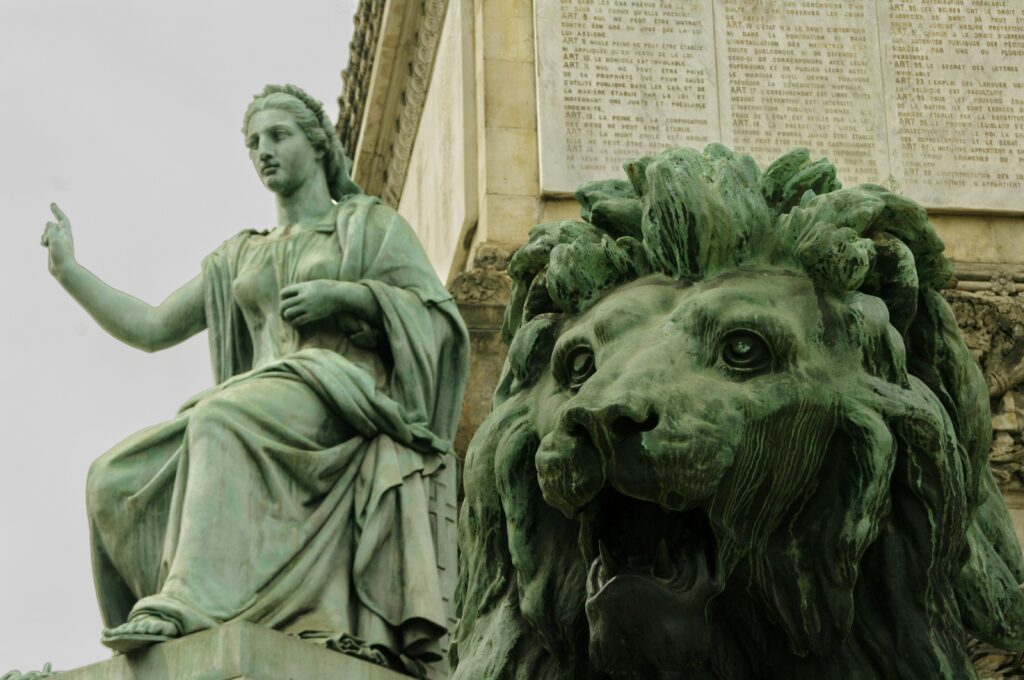 woman speaking and a lion statue